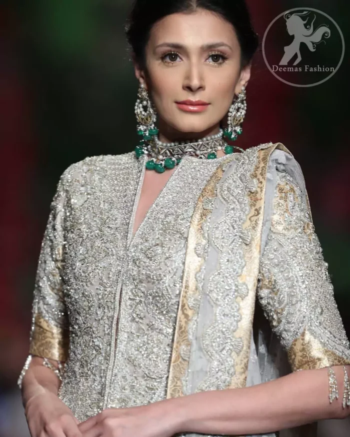 This dress is adorned with floral embroidery, highlighted with kora, dabka, tilla, sequins and pearls. It is allured with intricate embroidered motifs and delicate tassels. It is decorated with brocade applique. It comes with embellished lehengha. It is artistically coordinated with chiffon dupatta which is allured with four sided border.