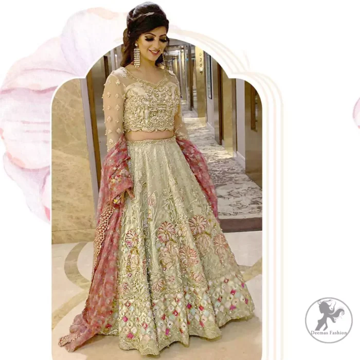 This dress is adorned with floral embroidery, highlighted with kora, dabka, tilla, sequins and pearls. It is allured with intricate embroidered motifs and detailed bodice. Blouse is scalloped. The border on hemline is enhanced with embellished floral pattern detailing, that instantly draws attention.It comes with embellished net lehengha with brocade lining. It is artistically coordinated with net dupatta which is allured with four sided border.