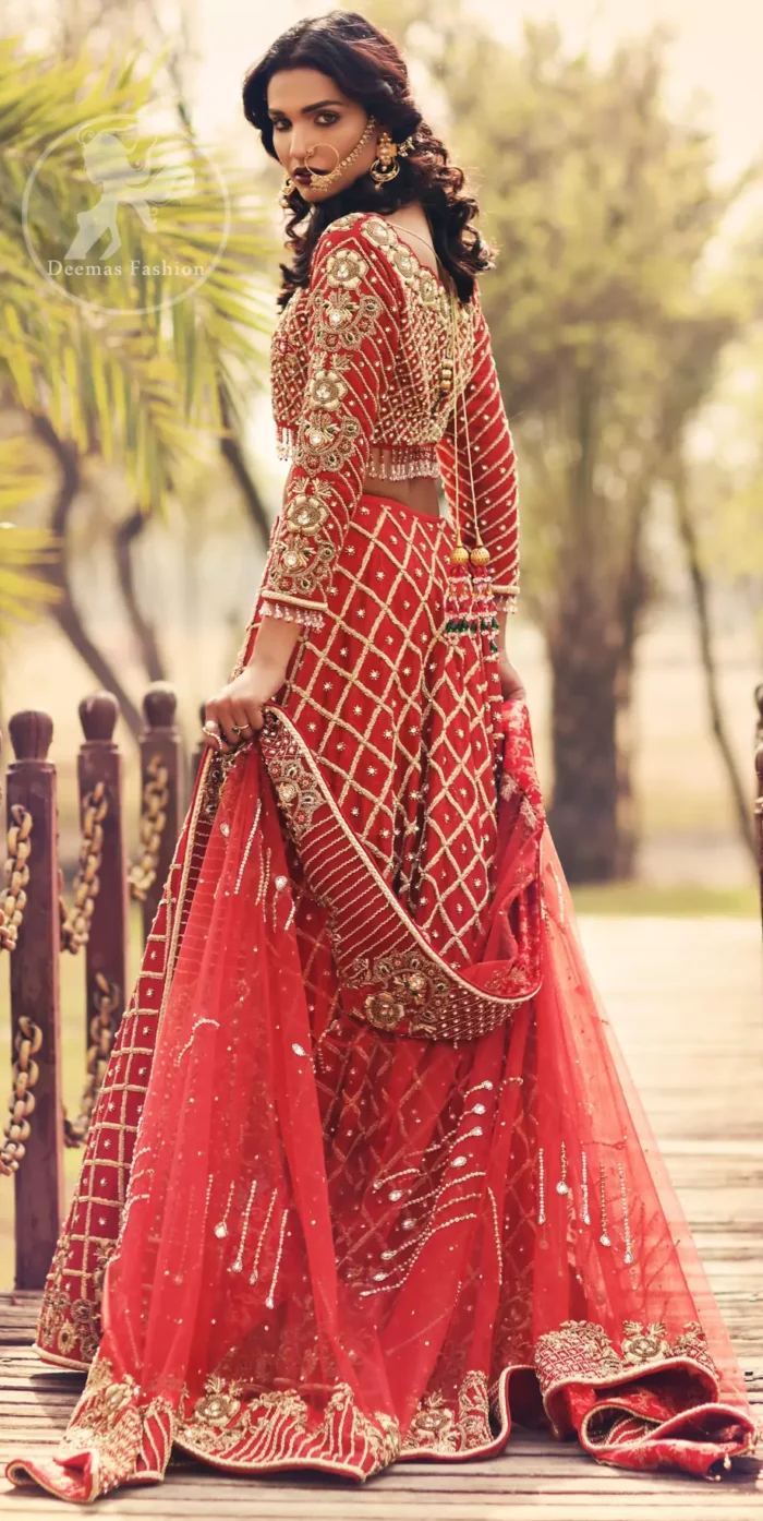 Boost your confidence and style in this glamorous blouse skirt with finest embroidery. The blouse is ornamented with light gold kora dabka, kundan and sequins work, elaborate it with tassels. The skirt is meticulously designed with vintage styled frames. It is further enhanced with light embroidered border along floral embroidery and zerdozi work. This outfit is coordinated with red dupatta with embroidered borders on all four sides and sprinkled sequins on the ground.