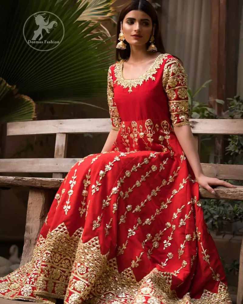 Exude elegance and class in this anarkali frock finessed with beautiful hand crafted embellishment. Embellished neckline and three quarter sleeves enhanced the look. It is further enhanced with verticle styled lines done with golden gotta work. It comprises with detail on bottom. Paired up with churidar pajama and ivory dupatta which is having embroidered border on sides.