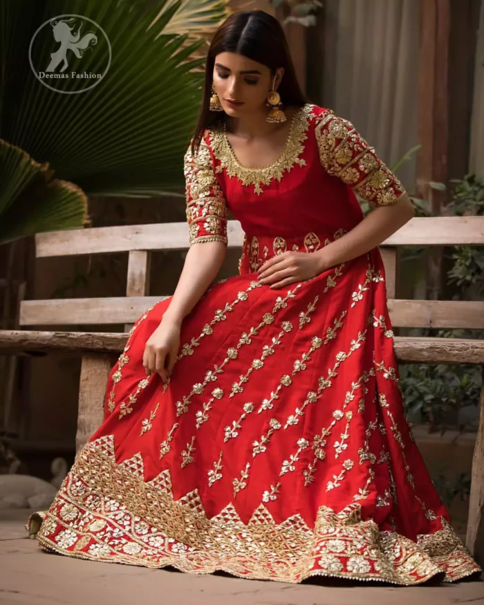 Exude elegance and class in this anarkali frock finessed with beautiful hand crafted embellishment. Embellished neckline and three quarter sleeves enhanced the look. It is further enhanced with verticle styled lines done with golden gotta work. It comprises with detail on bottom. Paired up with churidar pajama and ivory dupatta which is having embroidered border on sides.