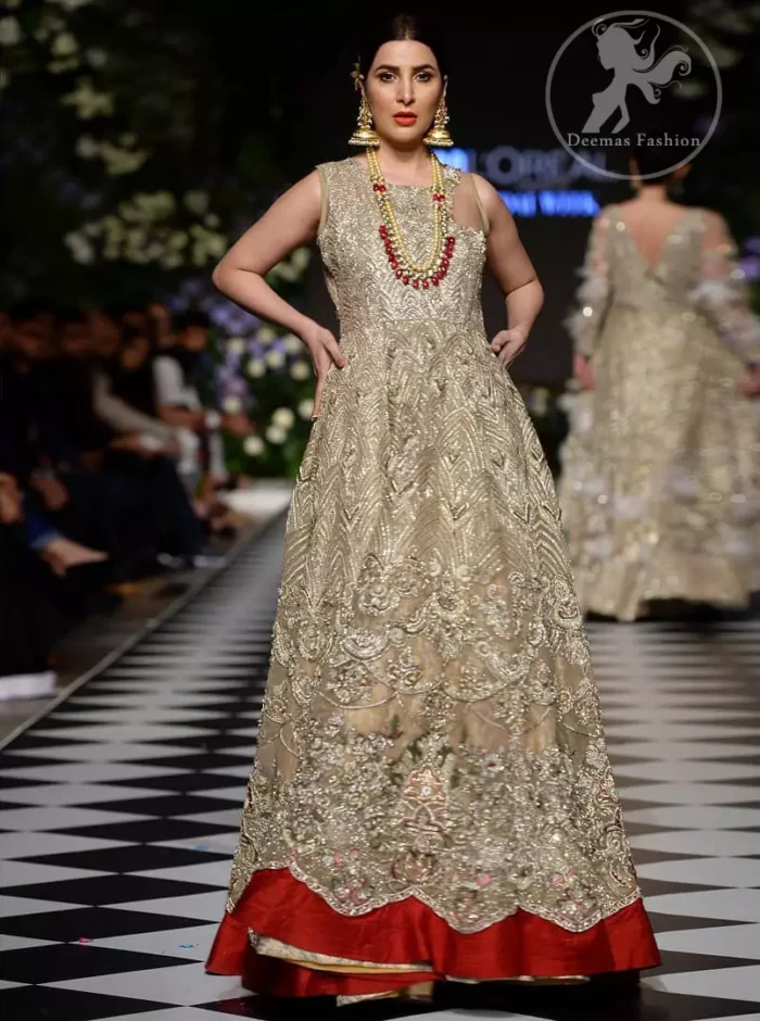 Delicately crafted and personifying chic elegance with an element of grandiose. This dress is beautifully sculptured with floral embroidery, adorned with cutwork borders embellished with dull gold and silver kora, dabka, pearl and sequins work all over. Moreover it is enhanced with different styles multiple colored embroidered motifs and finished with marron applique. This outfit comes with brocade pajama. It is coordinated with tissue dupatta which is sprinkled with sequins all over it. 
