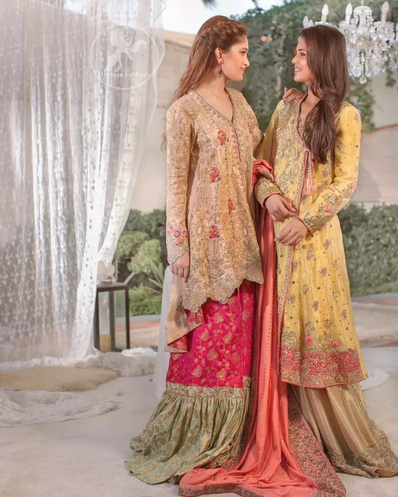 This outfit is perfect for mehendi mayon day. Heavily embellished in the front with intricate embroidered pattern done with golden kora dabka, kundan, tilla and sequins. Hemline is enhanced with peach embellished border adorned with kora dabka and thread embroidery. It is paired up with antique brass sharara with zerdosi work details on bottom. Dupatta having four sided embroidered edges and sequins spray.