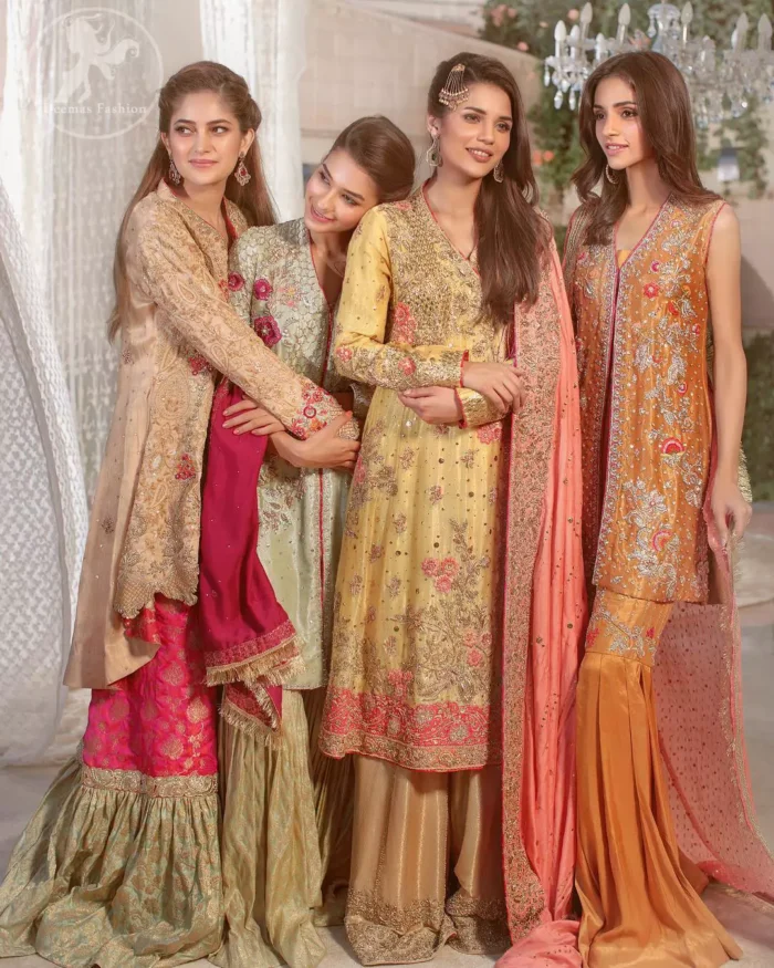 This outfit is perfect for mehendi mayon day. Heavily embellished in the front with intricate embroidered pattern done with golden kora dabka, kundan, tilla and sequins. Hemline is enhanced with peach embellished border adorned with kora dabka and thread embroidery. It is paired up with antique brass sharara with zerdosi work details on bottom. Dupatta having four sided embroidered edges and sequins spray.
