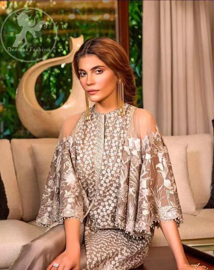 Bring out your beauty with this traditional yet modern thread embroidered gown decorated with embellished floral motif and swarovski crystals and pearls. Furthermore it is enhanced with scalloped border embellished with floral thread embroidery and complete the look with pearls ending. It comes with straight trousers embellished with lace. It is coordinated with chiffon dupatta which is sprinkled with sequins all over it.