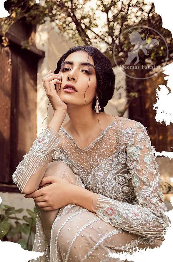 Exude elegance and class in this shirt finessed with beautiful embellished daaman. This dress is beautifully decorated with heavy embroidery. It is highlighted with silver kora, dabka, tilla, sequins and pearls. Bodice is ornamented with heavy embellishment and addition of tassels to complete the look. It comes with matching capri. It is coordinated with chiffon dupatta which is sprinkled with sequins all over it.