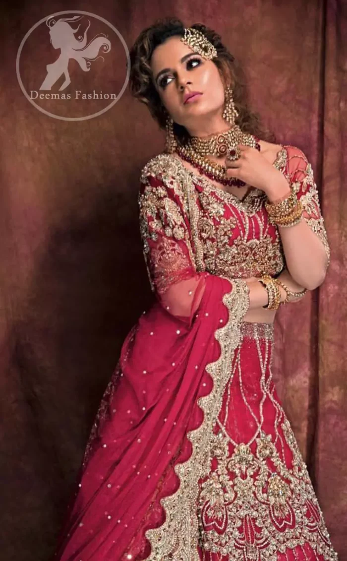 This dress is beautifully decorated with heavy embroidery. It is highlighted with dull golden kora, dabka, tilla, sequins and pearls. Fish lehengha is fully embellished.Blouse is scalloped. It comes with beautifull upper gown, sprinkled with sequins all over it. It is coordinated with chiffon dupatta which is sprinkled with sequins all over it.