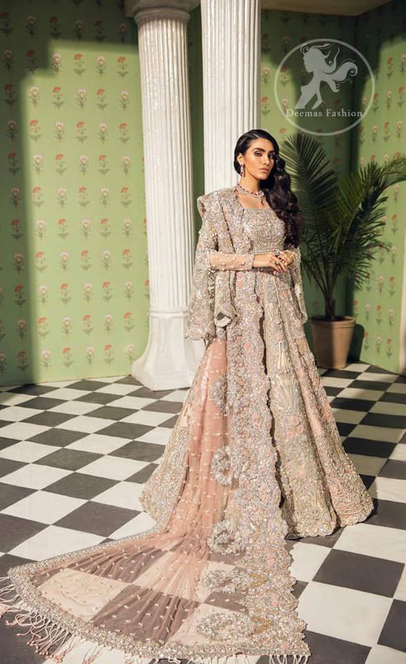 This dress is beautifully decorated with heavy embroidery. It is highlighted with dull golden kora, dabka, tilla, sequins and pearls. Fish lehengha is fully embellished.Blouse is scalloped. It comes with beautifull upper gown, sprinkled with sequins all over it. It is coordinated with chiffon dupatta which is sprinkled with sequins all over it.