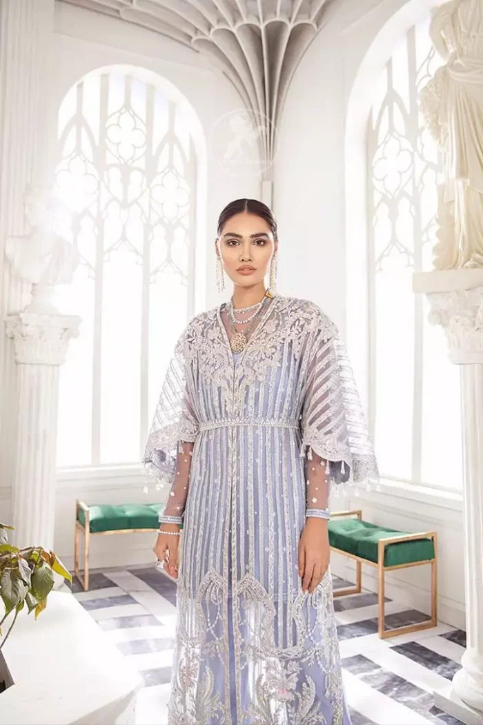 Steal the moment with our cold purple floor length gown emphasized with traditional neckline and intricate floral daaman enhanced with silver kora, dabka and sequins. It is adorned with fully embellished neckline and verticle lines, finished with floral thread embroidered hemline. Scalloped bell sleeves with tassels give it a perfect look. It comes with raw silk trousers. It is coordinated with chiffon dupatta which is sprinkled with sequins all over it.