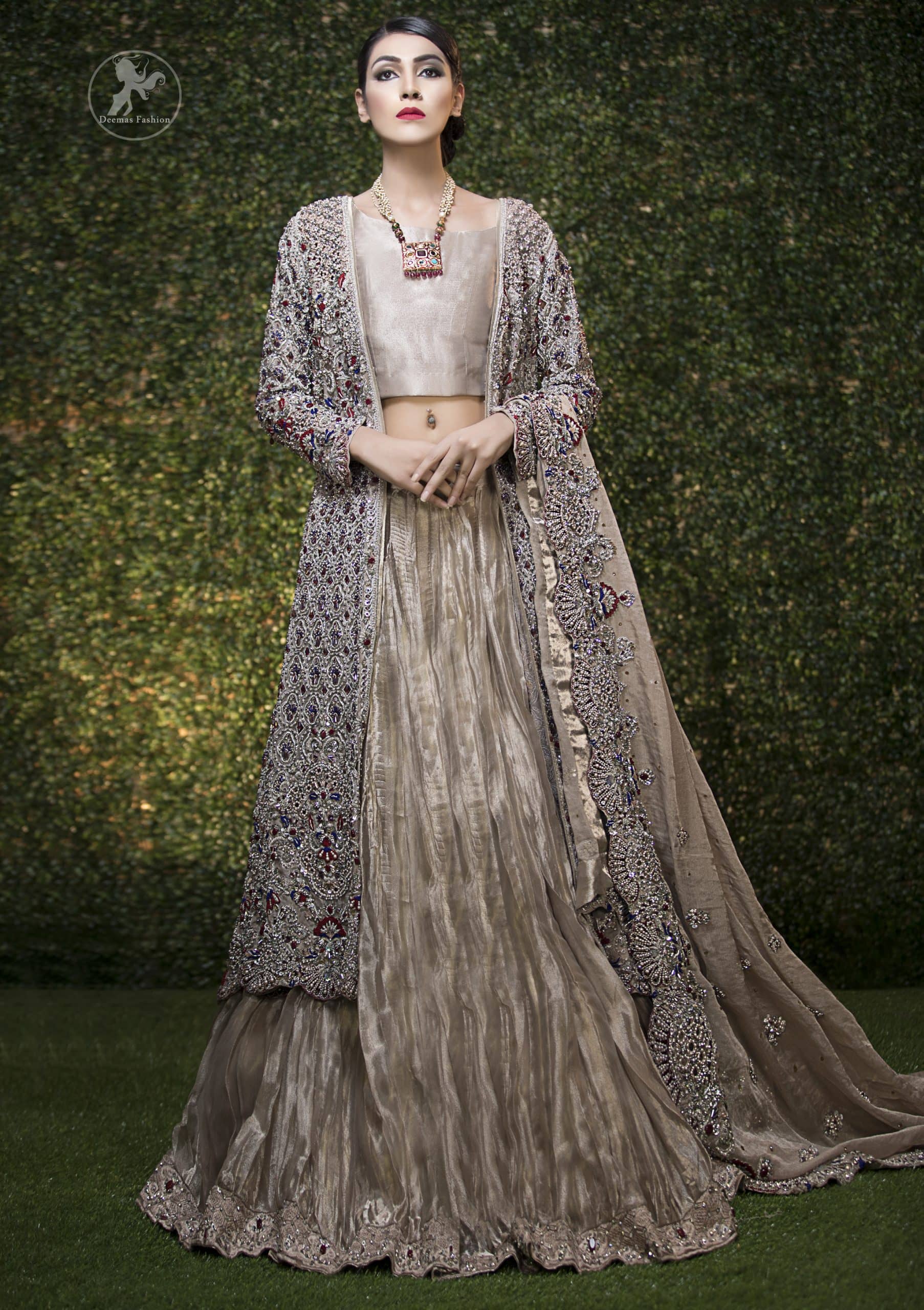This bridal dress is beautifully decorated with floral embroidery. Gown is allured with floral embroidery and embellished scalloped border. It is adorned with kora, dabka, tilla, sequins, stones and pearls. It comes with an exquisite lehengha with embroidered border to give it a regal look. Dupatta comprises of floral thread embroidery allured with embellished border and floral motifs all over it.