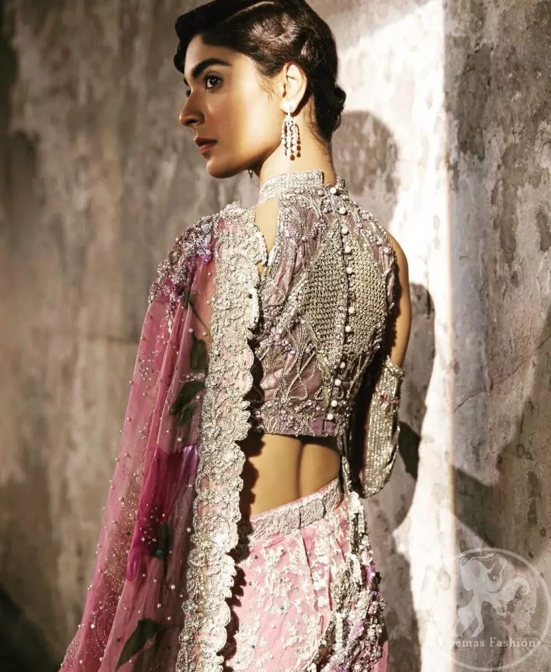 This dress is beautifully sculptured with floral embroidery. It comes with fully embroidered brocade blouse having halter neckline which adds to the look. Pallu is highlighted with kora, dabka, tilla, sequins and pearls. It is allured with scalloped embroidered border. Lehengha is fully embellished.