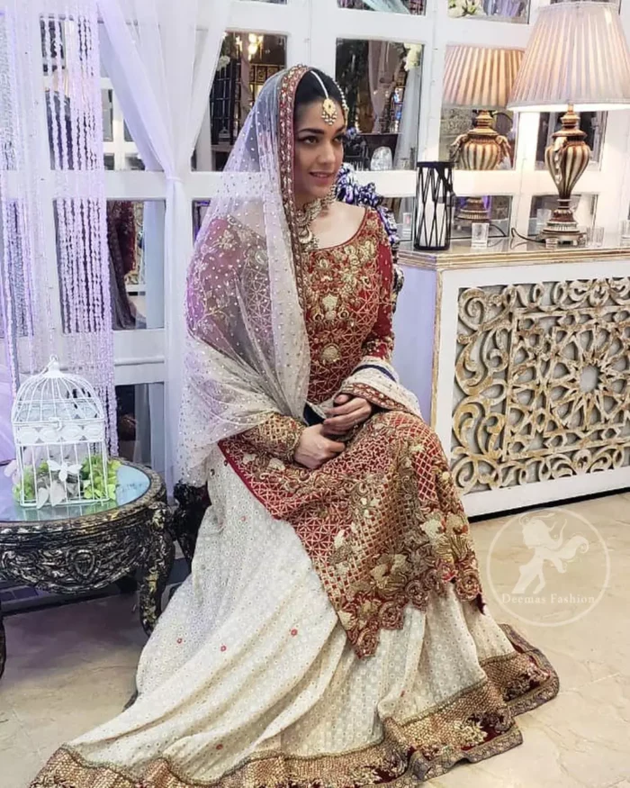 Make a dazzling impression in our zari embroidered copper rust shirt enhanced with intricately embellishmentswith gold and antique gold kora, dabka, tilla, sequins and pearls.It is paired up with thread embroidered chiffon lehengha having appliqued border around. Dupatta is sprinkled with stones all over it.