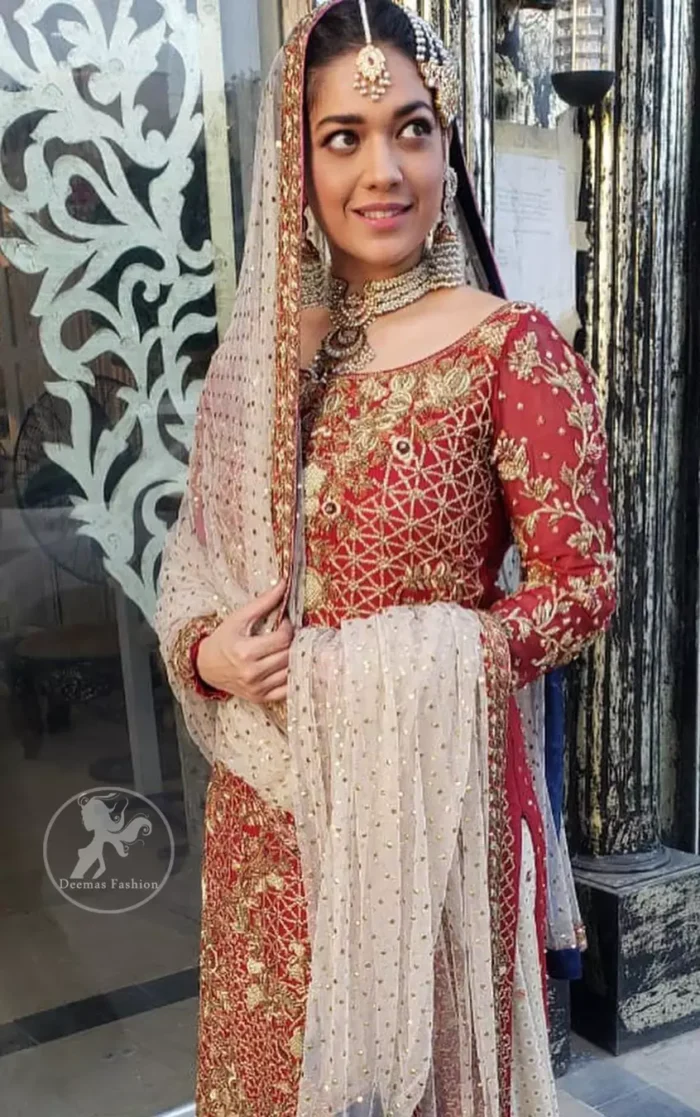 Make a dazzling impression in our zari embroidered copper rust shirt enhanced with intricately embellishmentswith gold and antique gold kora, dabka, tilla, sequins and pearls.It is paired up with thread embroidered chiffon lehengha having appliqued border around. Dupatta is sprinkled with stones all over it.