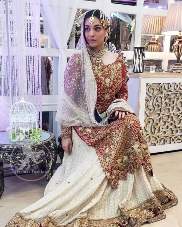 Make a dazzling impression in our zari embroidered copper rust shirt enhanced with intricately embellishmentswith gold and antique gold kora, dabka, tilla, sequins and pearls.It is paired up with thread embroidered chiffon lehengha having appliqued border around. Dupatta is sprinkled with stones all over it.