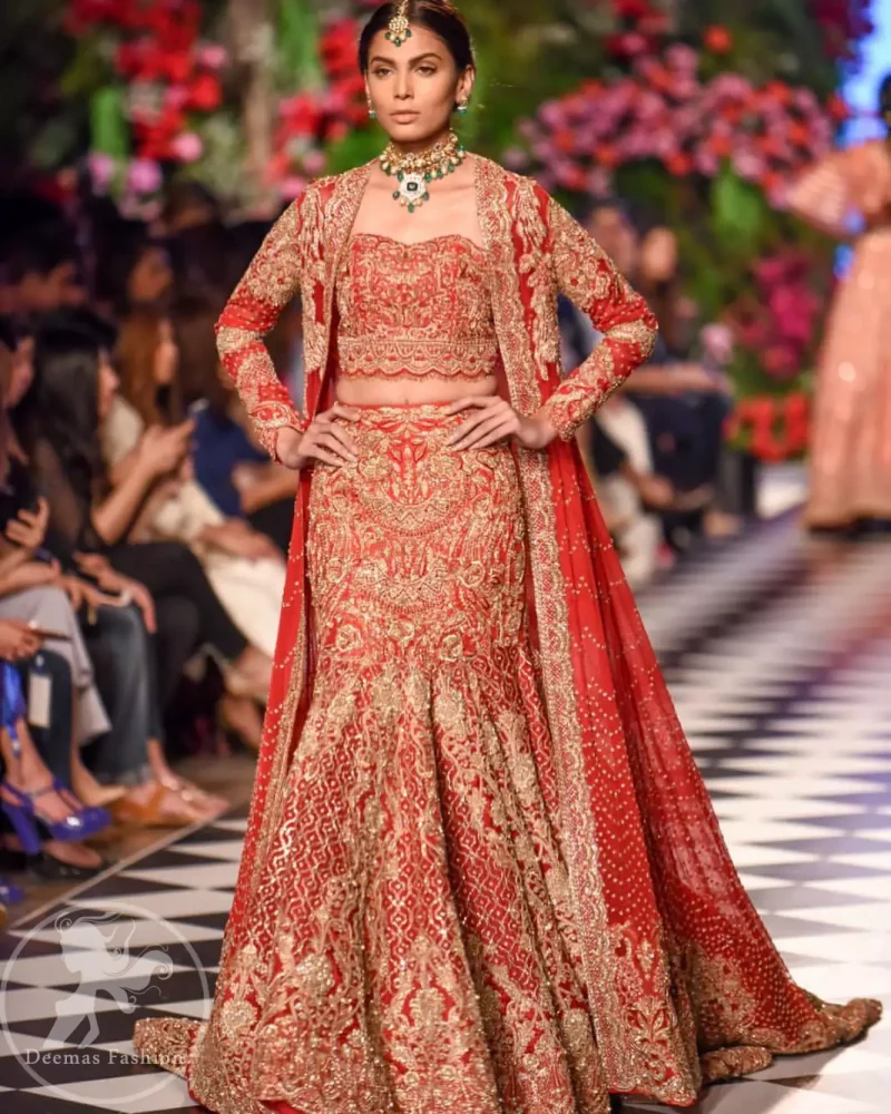 This dress is beautifully decorated with heavy embroidery. It is highlighted with dull golden kora, dabka, tilla, sequins and pearls. Fish lehengha is fully embellished.Blouse is scalloped. It comes with beautifull upper gown, sprinkled with sequins all over it. It is coordinated with chiffon dupatta which is sprinkled with sequins all over it.