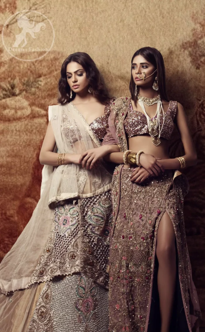 Brighten up your look with this outfit. The blouse is made of shimmer fabric to give its a regel look. It comes with full heavily embroidered lehenga with zardosi work details and rich hemline. This double layed lehenga is also enhanced with intricate embroidered net and multiple color embroidery. It is coordinated with tissue dupatta which is sprinkled with sequins all over it and pearls on the four sides of border.