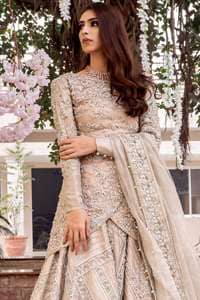 This outfit is adorned with kora, dabka, tilla, sequins and pearls. It is decorated with floral embellishments. It is overlapping shirt which adds to the look. It comes with heavy embellished lehengha allured with geometrical pattern all over it which has thick border on hemline. Tissue dupatta accompanies the garment. The dupatta has embellished borders on all four sides and small floral motifs all over it. The garment is lined with medium silk.
