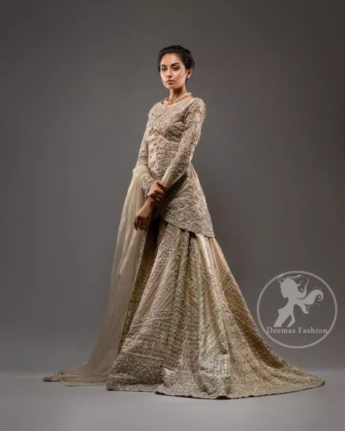 This outfit is adorned with kora, dabka, tilla, sequins and pearls. It is decorated with floral embellishments. It is overlapping shirt which adds to the look. It comes with heavy embellished lehengha allured with geometrical pattern all over it which has thick border on hemline. Tissue dupatta accompanies the garment. The dupatta has embellished borders on all four sides and small floral motifs all over it. The garment is lined with medium silk.