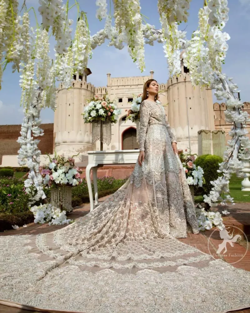 Reflecting exuberant color play in this ethereal piece meticulously highlighted with swarovski, pearl, silver kora and dabka. Heavily embellished in the front with intricate embroidered pattern and rich hemline. The sleeves are embellished with floral embroidery all over it. It comes with brocade pajama. This dress is paired with heavily embroidered organza dupatta that gives the right amount of glamour to the outfit. It is further furnished with four sided embellished border and geometric patterns.