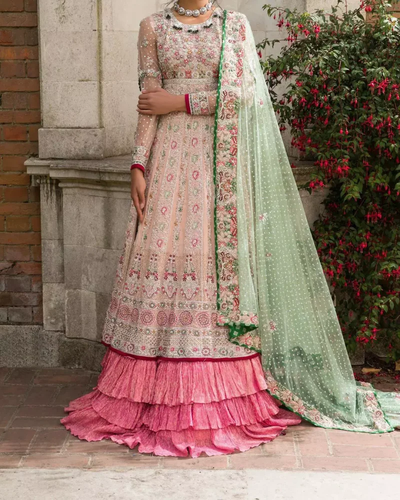 Opt for our ivory multiple-panel anarkali dress with exquisite embellishment on the bodice with pearls, sequins and silver kora, dabka. The daaman comprises of borders highlighted with floral embellished pattern. It is finished with deep blush frilled lehengha which adds to the bling. Dupatta is allured with four sided embellished border and sprinkled with stones all over it.