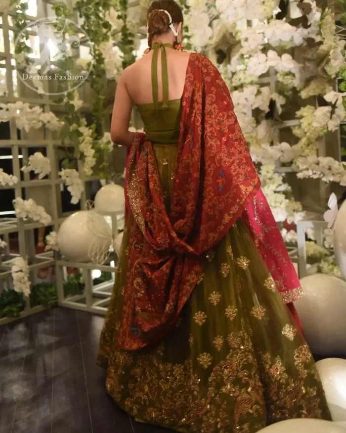 This dress is beautifully decorated with heavy embroidery. It is highlighted with dull golden kora, dabka, tilla, sequins and pearls. Fish lehengha is fully embellished.Blouse is scalloped. It comes with beautifull upper gown, sprinkled with sequins all over it. It is coordinated with chiffon dupatta which is sprinkled with sequins all over it.