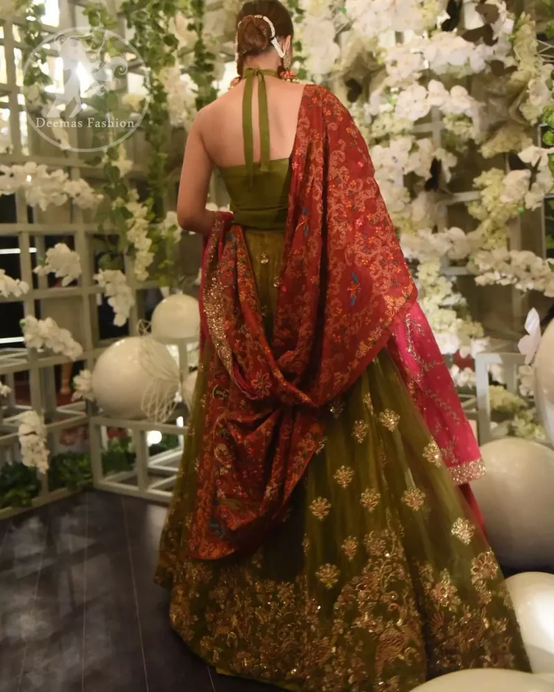 This dress is beautifully decorated with heavy embroidery. It is highlighted with dull golden kora, dabka, tilla, sequins and pearls. Fish lehengha is fully embellished.Blouse is scalloped. It comes with beautifull upper gown, sprinkled with sequins all over it. It is coordinated with chiffon dupatta which is sprinkled with sequins all over it.
