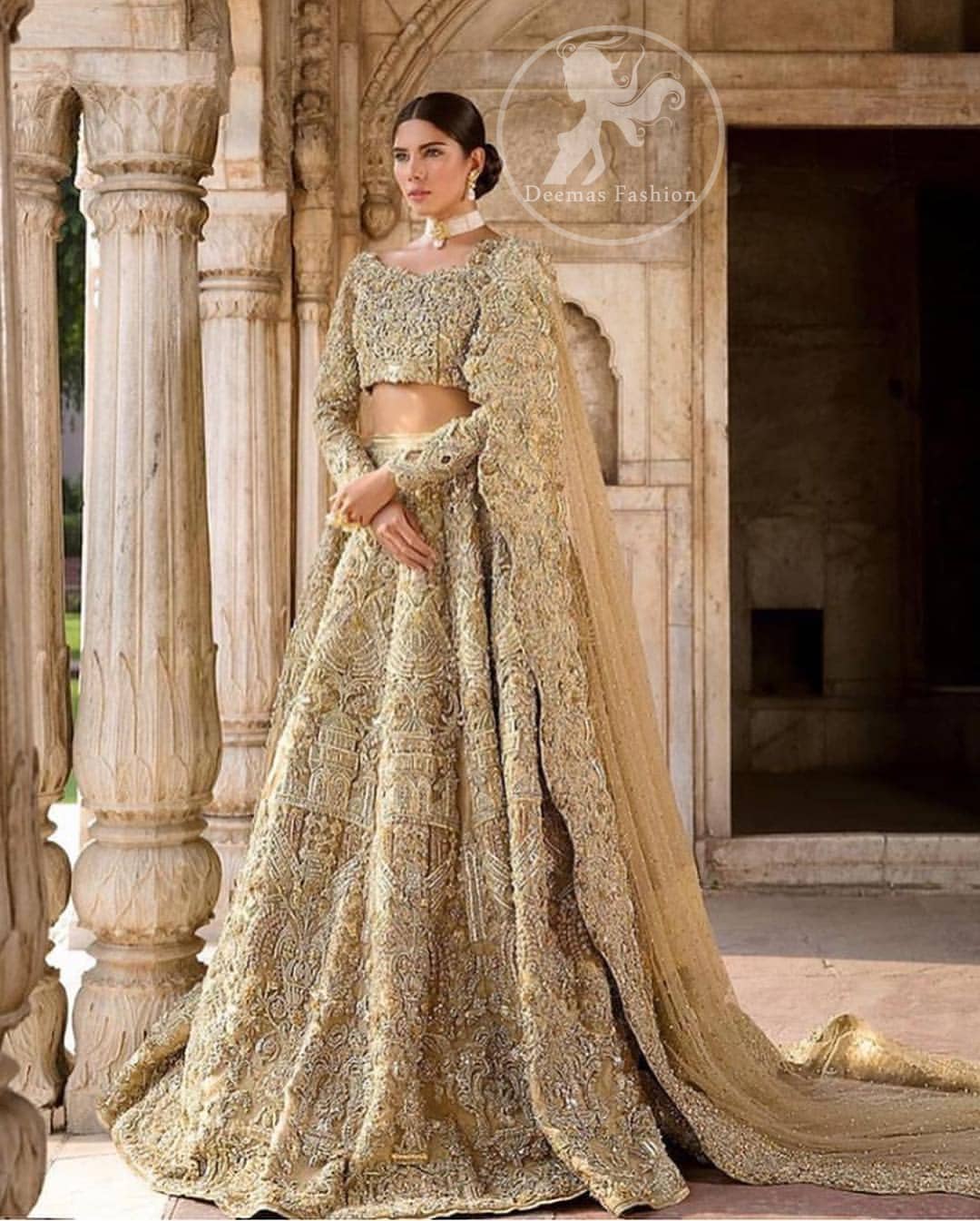 The grand gold bridal stands out due to its uniqueness and the perfect fusion of modern cut and traditional embroidery. This outfit is made of rich floral embroidery and different styles motifs which is further enhanced with zardoze work. It is highlighted with kora, dabka, tilla, sequins and pearls. Heavily embellished lehnga with embroidered motifs spread all over and finished with thick kora and dabka borders completes the look. It is coordinated with beautiful dupatta with thick matha patti border on the front and intricate beautiful border on all rest of the three sides. Furthermore it is enhanced with sprinkled sequins all over it.