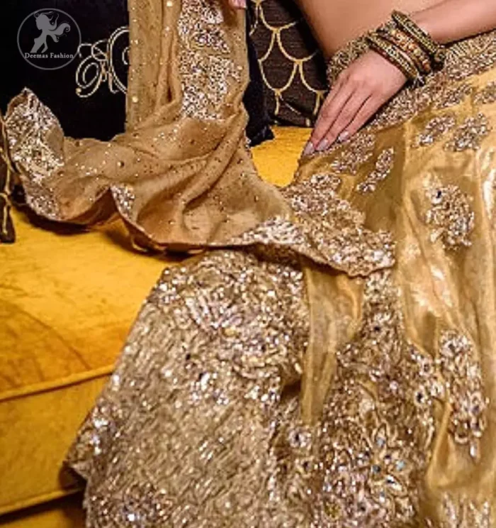 This bridal dress is perfect for your special day. Blouse is beautifully decorated with floral embroidery and embellished scalloped border. It is adorned with kora, dabka, tilla, sequins and pearls. It comes with an exquisite lehengha with thick embroidered border to give it a regal look. Dupatta comprises of floral thread embroidery allured with thick embellished border