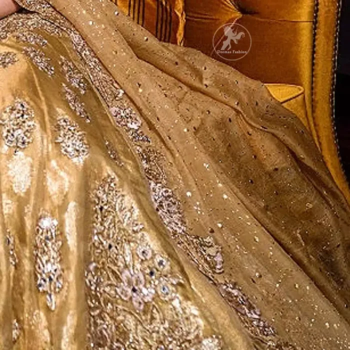 This bridal dress is perfect for your special day. Blouse is beautifully decorated with floral embroidery and embellished scalloped border. It is adorned with kora, dabka, tilla, sequins and pearls. It comes with an exquisite lehengha with thick embroidered border to give it a regal look. Dupatta comprises of floral thread embroidery allured with thick embellished border