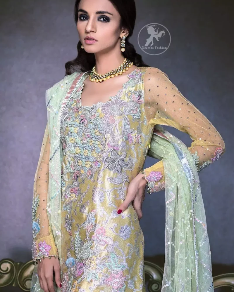 This super stunning  shirt is made of rich floral embroidery which is further enhanced with colorful gota work.  It is highlighted with gota work, sequins and pearls. The detailed scalloped border gives a perfect ending to this shirt. It comes with indian khaki trouser. It is coordinated with chiffon dupatta which is sprinkled with sequins all over it.