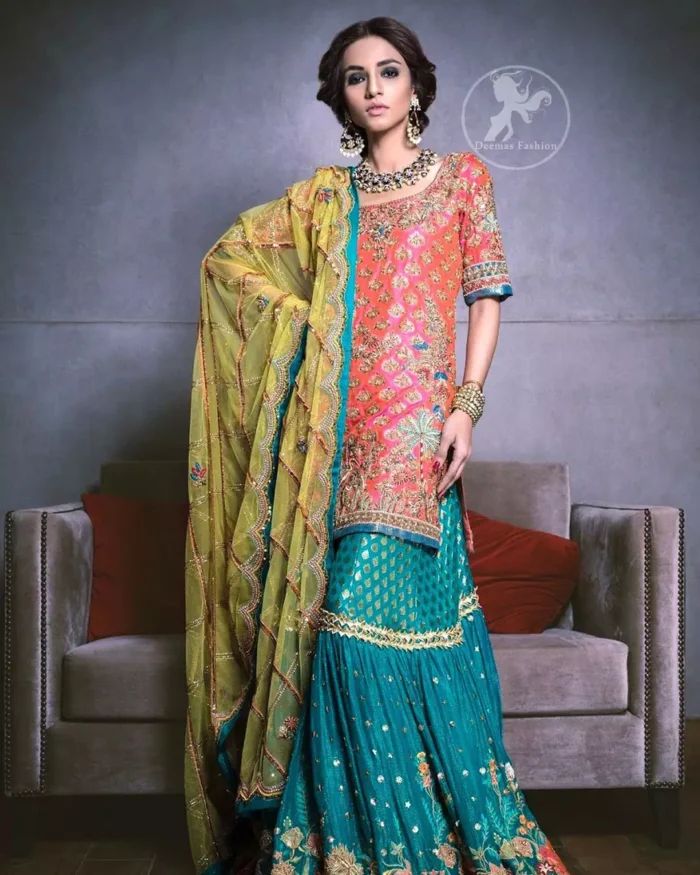 Our tea rose shirt with exquisite embellished neckline and back neckline in kora, dabka sequins and intricate thread work. The daaman is emphasized on intricate floral details that gives perfect ending to this shirt. It is coordinated with farshy gharara decorated with embroidery. The gradient turmeric dupatta has crisscross pattern and floral motifs scattered. It is finished with jamawar piping all around the edges.