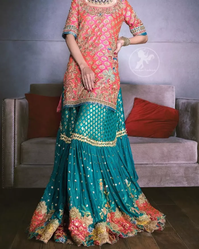 Our tea rose shirt with exquisite embellished neckline and back neckline in kora, dabka sequins and intricate thread work. The daaman is emphasized on intricate floral details that gives perfect ending to this shirt. It is coordinated with farshy gharara decorated with embroidery. The gradient turmeric dupatta has crisscross pattern and floral motifs scattered. It is finished with jamawar piping all around the edges.