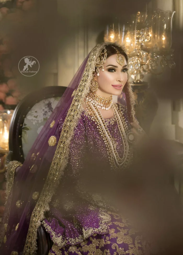 Reflecting royalty and the majestic beauty of statuesque shape and silhouette this bridal dress is perfect for your special day. This dress is beautifully decorated with heavy embroidery. It is highlighted with golden kora, dabka, tilla, sequins and pearls. The short shirt is decorated from neckline and scalloped hemline is decorated with zardosi work. Lehenga is enhanced with floral patterns all over with golden embellishment.  It is coordinated with chiffon dupatta which is sprinkled with small floral motifs all over.