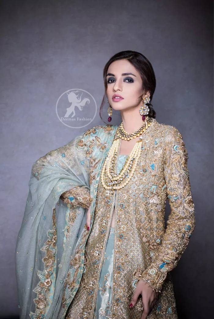 This regal regent gray outfit is an immensely captivating traditional piece, enhancing the art of classical heritage showcasing the craftsmanship of kora, dabka & mukesh detailed with pearls; artistically embellished to give a beautiful rhythm to the outfit. Gown is heavily embellished with antique zardosi work and floral thread embroidery. It comes with embellished lehenga enhanced with embroidered applique on the bottom. It comes with organza dupatta with embellished scalloped border at all ends.