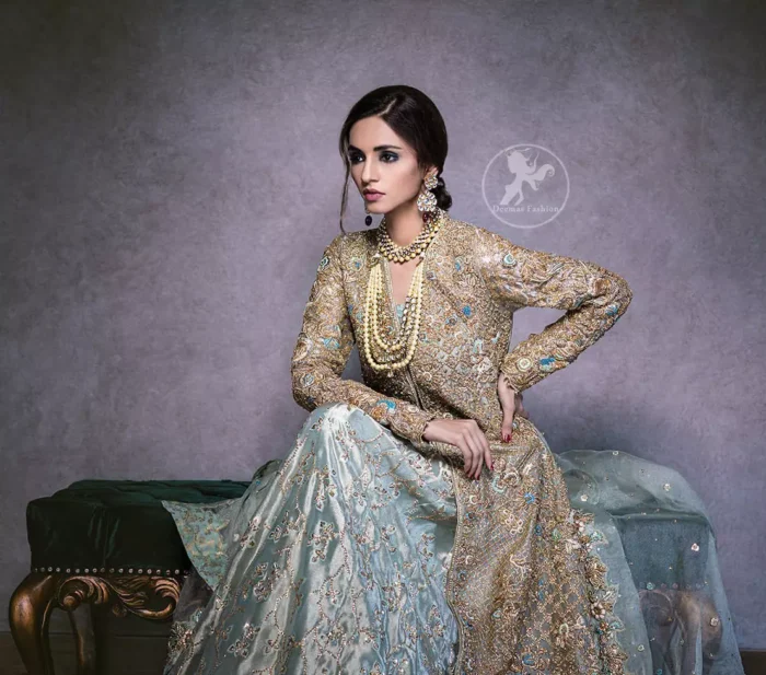 This regal regent gray outfit is an immensely captivating traditional piece, enhancing the art of classical heritage showcasing the craftsmanship of kora, dabka & mukesh detailed with pearls; artistically embellished to give a beautiful rhythm to the outfit. Gown is heavily embellished with antique zardosi work and floral thread embroidery. It comes with embellished lehenga enhanced with embroidered applique on the bottom. It comes with organza dupatta with embellished scalloped border at all ends.