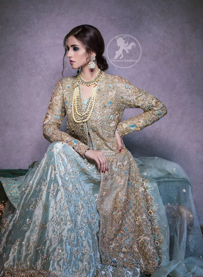 This regal regent gray outfit is an immensely captivating traditional piece, enhancing the art of classical heritage showcasing the craftsmanship of kora, dabka & mukesh detailed with pearls; artistically embellished to give a beautiful rhythm to the outfit. Gown is heavily embellished with antique zardosi work and floral thread embroidery. It comes with embellished lehenga enhanced with embroidered applique on the bottom. It comes with organza dupatta with embellished scalloped border at all ends.