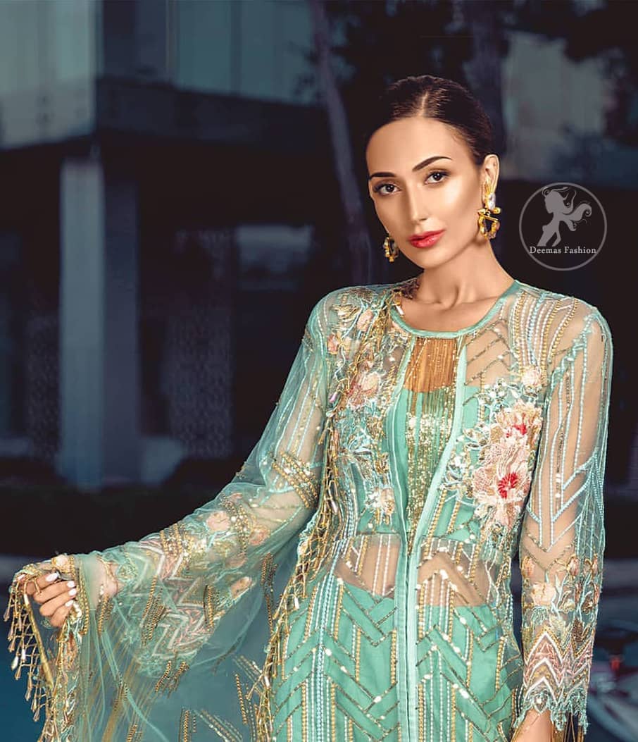 A must have creation for day to evening wear. Reflecting exuberant color play in this ethereal piece meticulously highlighted with swarovski, pearl, silver kora and dabka. It is also decorated with multiple color thread embroidery and golden tassels. It comes with full embroidered bell sleeves. This outfit is coordinated with raw silk bell bottom. The outfit comprises with tissue dupatta which is sprinkled with sequins on the ground.