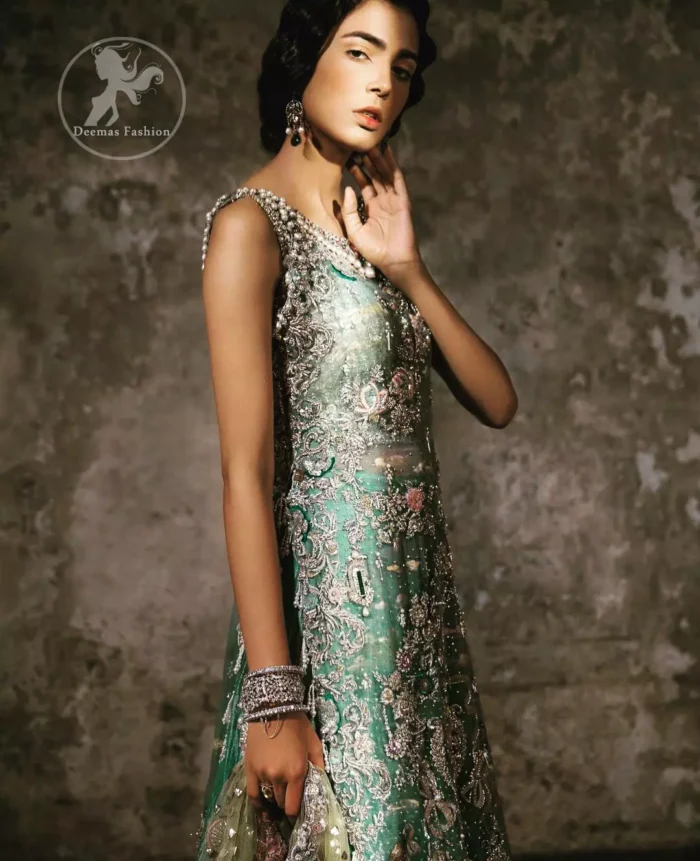 Delicately crafted and personifying chic elegance with an element of grandiose. Heavily embellished in the front with intricate embroidered pattern done with golden and silver kora, dabka, kundan, tilla and sequins. It is further decorated with scalloped boder which having tassels to complete the look. The back of the shirt is embellished with different types of motifs. It comes with matching sharara sprinkled small motifs all over. It is coordinated with olive green chiffon dupatta which is sprinkled with sequins all over it.