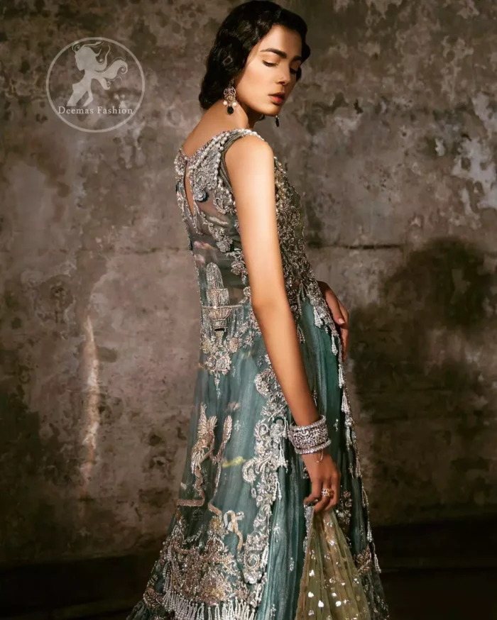 Delicately crafted and personifying chic elegance with an element of grandiose. Heavily embellished in the front with intricate embroidered pattern done with golden and silver kora, dabka, kundan, tilla and sequins. It is further decorated with scalloped boder which having tassels to complete the look. The back of the shirt is embellished with different types of motifs. It comes with matching sharara sprinkled small motifs all over. It is coordinated with olive green chiffon dupatta which is sprinkled with sequins all over it.