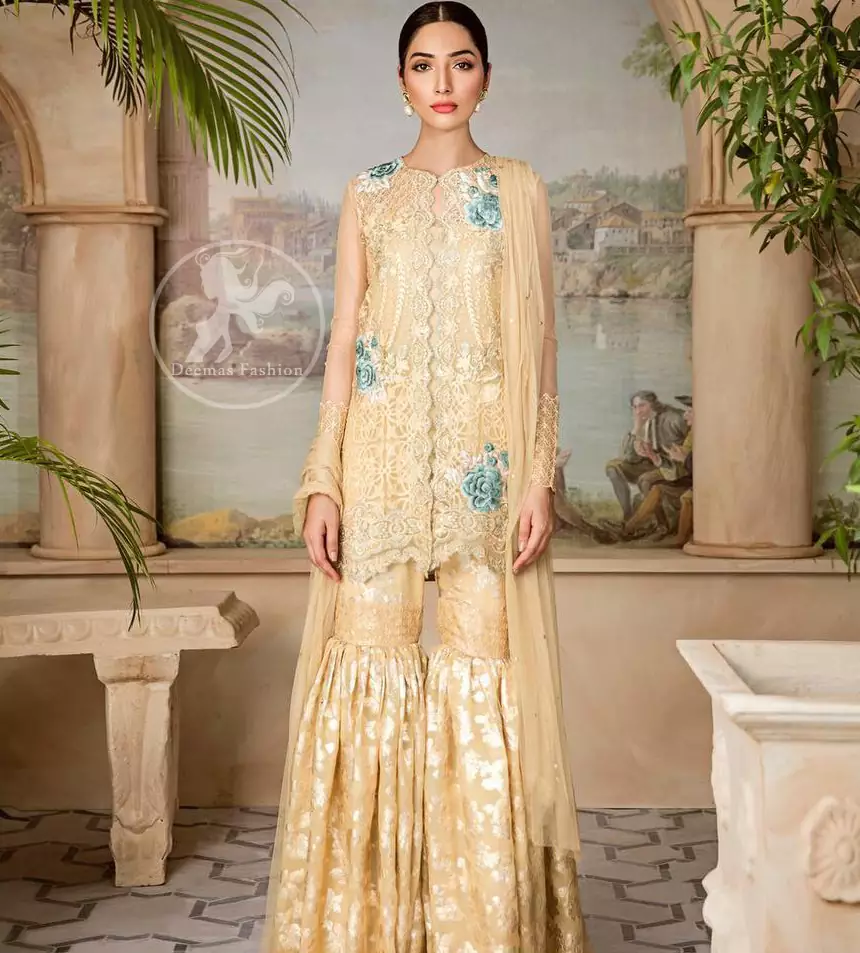 Boost your confidence and style in this glamorous attire accentuated with finest thread work embroidery and cut work hemline. This open shirt having full length sleeves and decorated with embroidery at the end. It comes with brocade gharara. It is coordinated with tissue dupatta which is sprinkled with sequins all over it.