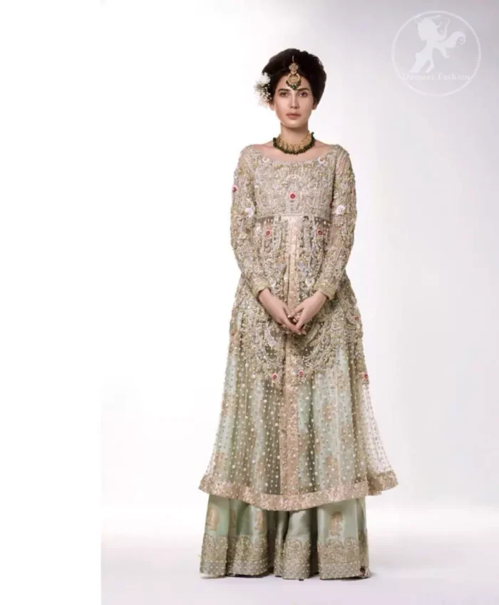 The perfect combination of tradition and class. Dazzle in this made to perfection, richly embroidered front open net outfit decorated with intricate zardozi embroidered front highlighted with kora, dabka, tilla, sequins and pearls embroidered borders on daaman and sleeves. Furthermore the shirt is fully decorated with sprinkled pearls all over it. This outfit is comprises with light olive green sharara highlighted with zardozi details at the bottom. Complete the look with tea rose dupatta sprinkled with sequins all over.