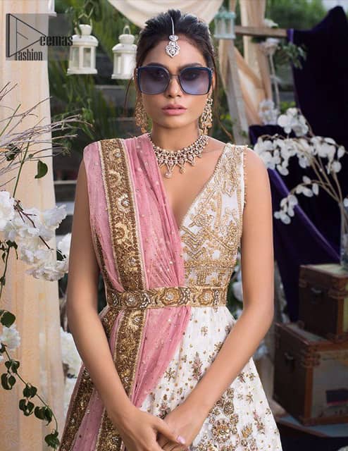 This dress is majestic beauty and perfect for your engagement or evening ensemble. Delicately crafted and personifying chic elegance with an element of grandiose. This floor length maxi is decorated with intricate thread and kora, dabka embroidery on bodice and floral motifs details all over the front on ivory canvas. The bottom of the maxi is enhanced with embellished applique. It comprises with churidar pajama. It comes with net dupatta with embellished border at all ends. Style it up with embroidered waist belt.