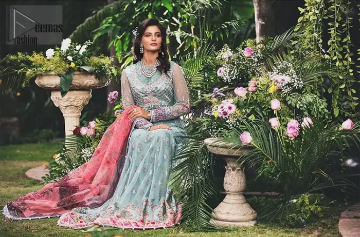 Gussy up in this luxuriously designed pishwas emboldened with intricate embroidery along with beautiful rich patterns and delicate details at the daaman. The front open jacket executing heavily hand crafted art of zardosi, kora and dabka with splashes of silver and pink floral motifs is a classical visit to feminine personification. Having full length sleeves adorned with floral bootis and lace details. It comprises with matching churidar pajama. Style it with self printed net dupatta having four sided thin border and dangling balls on all four sides.