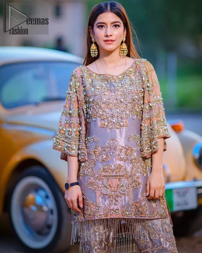 Tradition meets modernity. This outfit is stunningly perfect for any evening ensemble. This dress is beautifully sculptured with floral embroidery, adorned with bell sleeves embellished with antique shaded kora, dabka, pearl, sequins and multiple color resham embroidery all over. The bottom of the shirt is enhanced with rich zardosi embroidery and finishing with tassels at the end. It comprises with fully embellished gharara. Pair it up with matching dupatta ornamented with scattered tiny floral motifs and sequins.