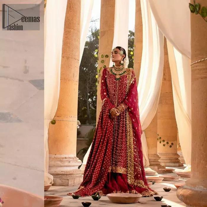 A must have creation for your wedding day. This traditional front open style bridal is aesthetically designed with sequins beads details, embellished with kora, dabka, nakshi and sequins. The daaman is emphasized with intricate zardosi details that gives perfect ending to this pishwas. Style it up with artfully coordinated maroon sharara finessed with golden zardosi details at the bottom. The dupatta incorporates beautifully designed borders on all four sides, focusing on the criss cross pattern to give it a perfect look.