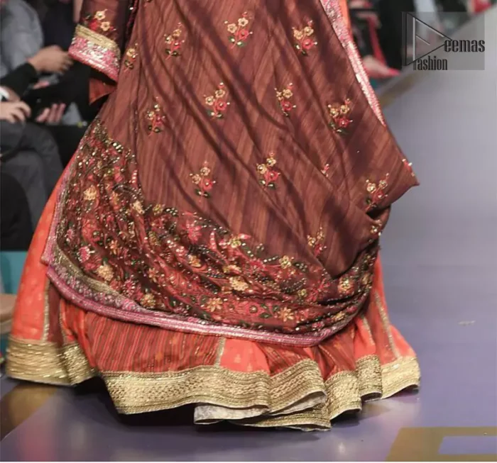 This dress is majestic beauty and perfect for mehndi mayon day. Delicately crafted and personifying chic elegance with an element of grandiose. A full heavily embellished blouse with multiple color resham thread embroidery and mirror work details. Having half sleeves adorned with mirror work. It comprises with self printed lehenga finishing with dull golden lace at the end. Style it confidently with chocolate brown dupatta with thick embellished border on the front and comparatively lighter work border on long edges. Medium and tiny sized ornamental motifs scattered all-over.