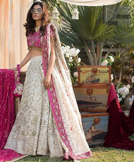 This dress id perfect for Reception or Nikah day. The bridal stands out due to its uniqueness and the perfect fusion of modern cut and traditional embroidery. Make your big day more interesting with this shabby chic statement intensified with rich zardosi work all over the front and bold patterns at daaman. The blouse is fully embellished with champagne and antique shaded embroidery all over and finishing with tassels. The outfit is beautifully coordinated with self printed dupatta adorned with shocking pink embellished applique on all four sides.