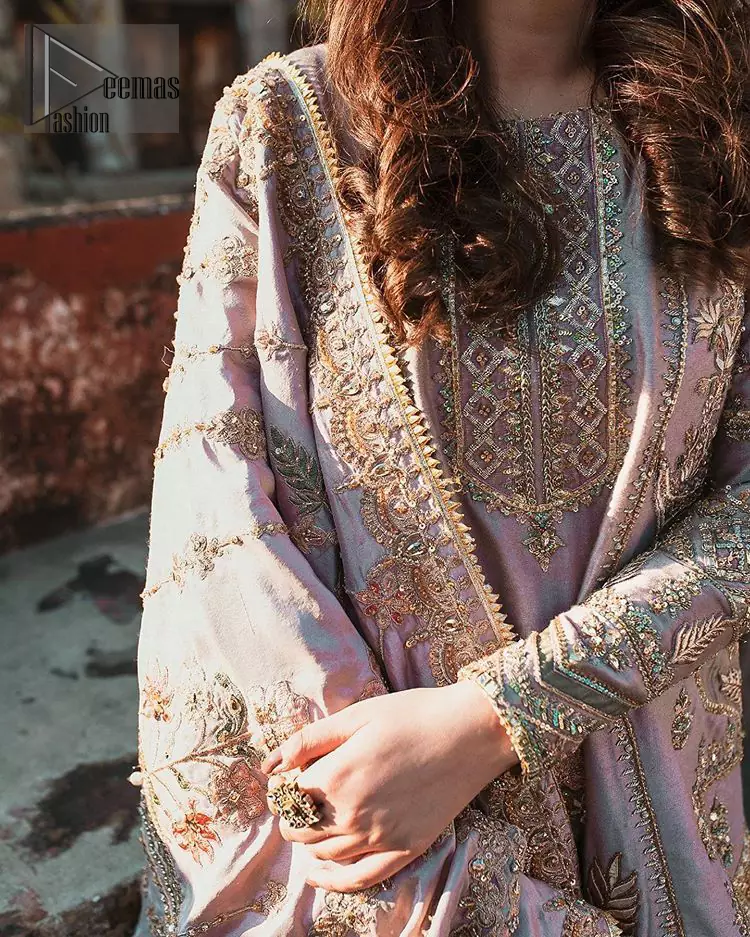 This dress is perfect for your Nikah and Engagement function. This super stunning frock is made of rich floral embroidery and geometric patterns which is further enhanced with gota work. Having full length sleeves adorned with motifs. Multiple color thread embroidery gives it a classical look. It comprises with cigarette pants ornamented with gota work and thread embroidery details. Style it confidently with raw silk fully embroidered dupatta adorned with geometric patterns and also having four sided border.