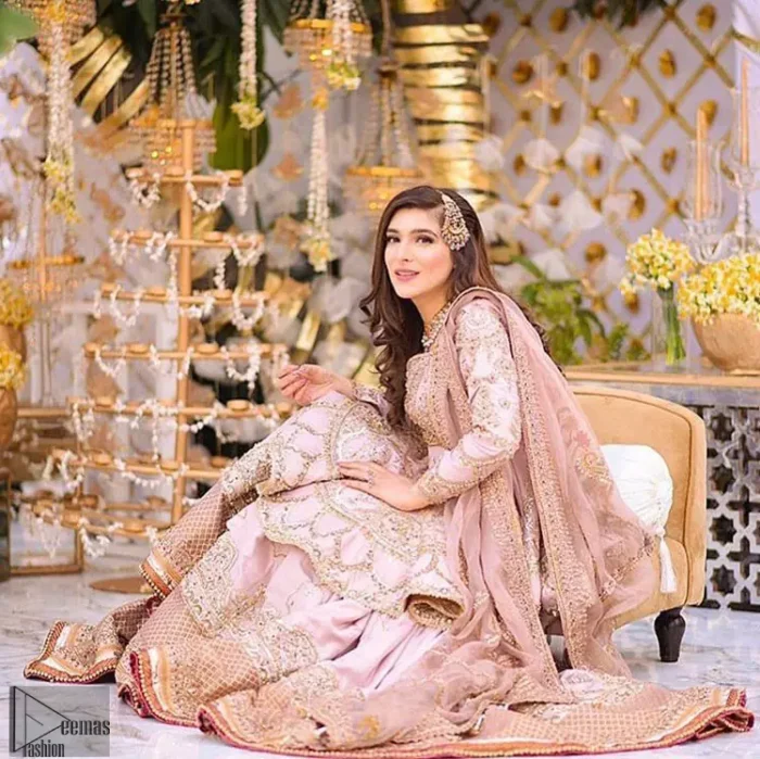Brighten up your look with this outfit on your reception or nikah day. Wear this soft and supple hues richly decorated by shades of golden and silver with gota work motifs and geometric patterns at daaman. Having embellished bodice and full length sleeves adorned with geometric patterns and motifs. Style it up with artfully coordinated tea pink gharara finessed with floral motifs and gota work details at the bottom. Thin border on all four sides of the dupatta which have gold tila embroidery with sequins, beads and crystal touching.