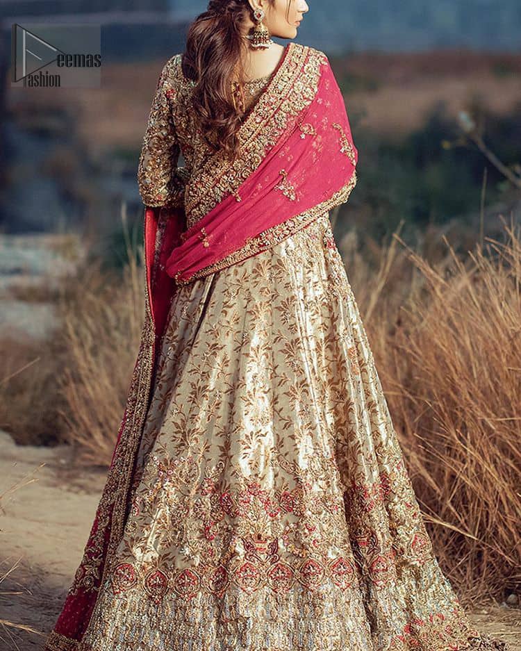This dress is majestic beauty. A jacquard fabric maxi adorning personification of a majestic look with a contemporary silhouette showcasing the timeless art of zardosi, naqshi, kora, dabka and thread work, having full length scalloped sleeves with ethereally handcrafted golden zardosi work and resham embroidery. The bottom of the maxi is enhanced with rich floral embroidery and motifs pattern. It comprises with matching churidar pajama. The dupatta incorporates beautifully designed borders on all four sides, focusing on the heavily embellished pallu borders to give it a perfect maharani look.